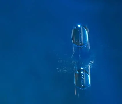 A drop of water on a blue background Stock Photos
