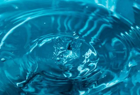 Drop of water. Blue water drop. Falling water. Water splash close-up.. Stock Photos