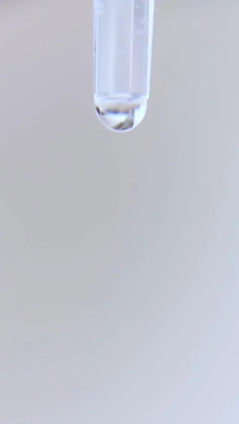 A drop of water close-up dripping into the bottom. Stock Footage 242519892