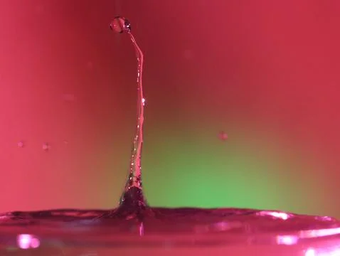 Drop of water colliding when it bounces and forming a palm tree Stock Photos