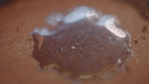 A drop of water dries quickly on ground coffee Stock Footage 118127882