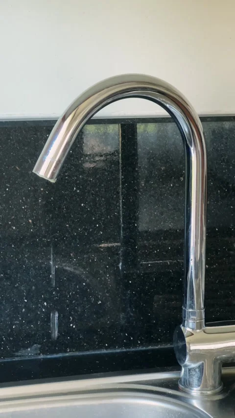 Drop of water drips from the tap. Broken chrome faucet in the kitchen. Everyday Stock Footage 280906751