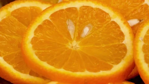 A drop of water drops on a slice of orange Stock Footage 233620667