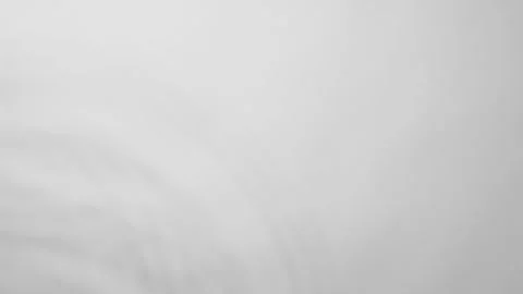 Drop of water falling down and making circles on surface. Slow motion Stock Footage 243391293