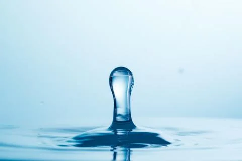 Drop of water falling down in the water Stock-Fotos