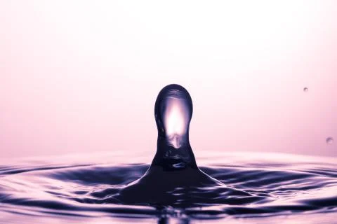 Drop of water falling down in the water Stock-Fotos