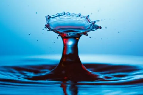 Drop of water falling down in the water Stock-Fotos