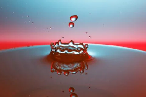 Drop of water falling down in the water Stock-Fotos