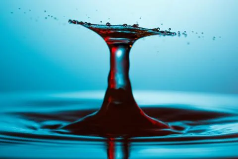 Drop of water falling down in the water Stock-Fotos