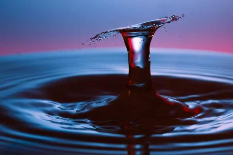 Drop of water falling down in the water Stock-Fotos
