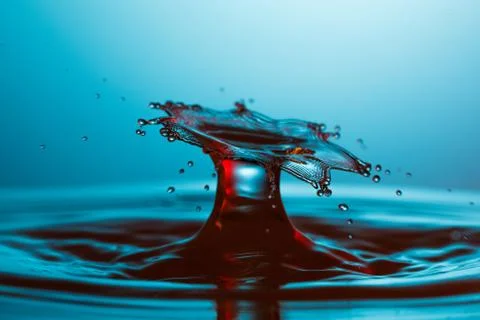 Drop of water falling down in the water Stock-Fotos