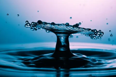 Drop of water falling down in the water Stock-Fotos
