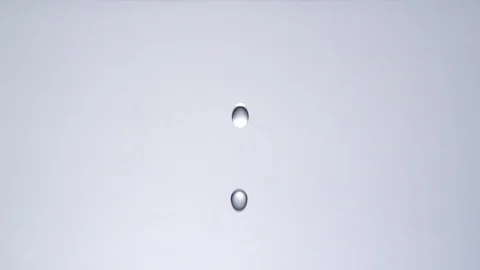 Drop of water falling into a pale of water in slowmotion HD Stock Footage 99233629
