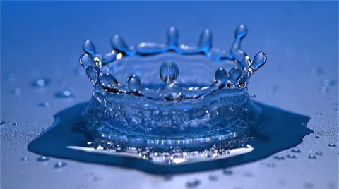 Drop of Water falling into Water against Blue background, Slow motion Stock Footage