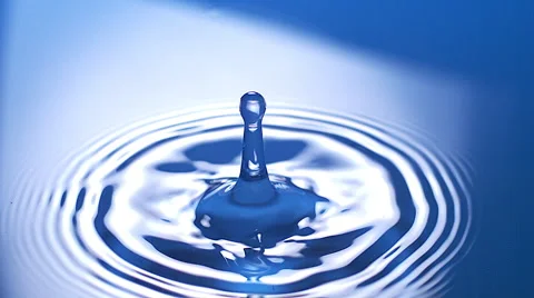 Drop of Water falling into Water against Blue background, Slow motion Stock Footage