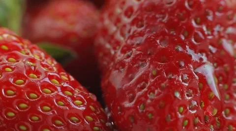 A drop of water falls on fresh, ripe, juicy, delicious strawberries. Macro shot. Stock Footage 50307771
