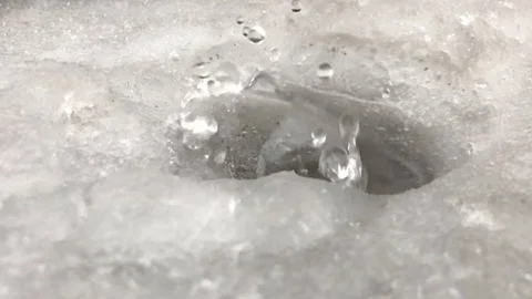 A drop of water falls on the ice. Slow motion Stock-Footage 111180594