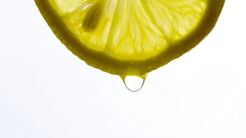 Drop of water falls from the lemon on a white background. Stock Footage 127570112