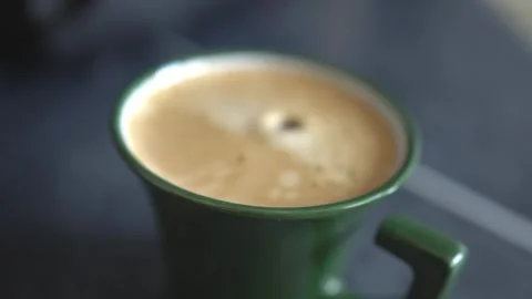 A drop of water falls into a mug of coffee with crema. Stock Footage 309190268