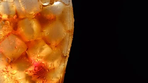 A drop of water flows down a cold glass with cola Stock-Footage 121660203