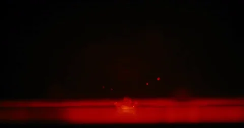 Drop of water hitting red water surface Stock-Footage 77568872
