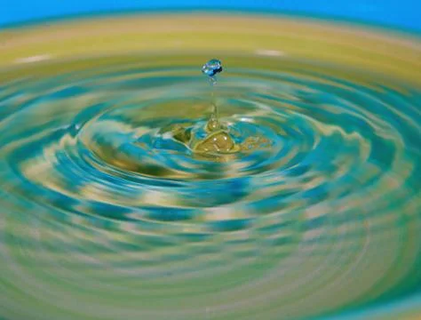 Drop of water or fluid created a ripple Stock Photos