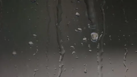 A drop of water slides down the glass surface of a window Stock Footage 340425197