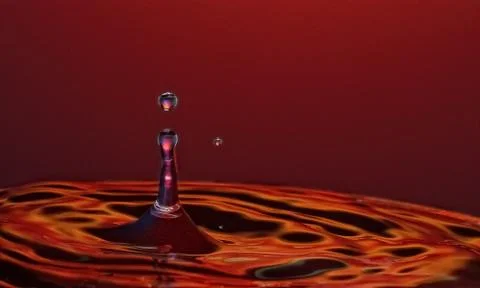 Drop of water spray Stock Photos