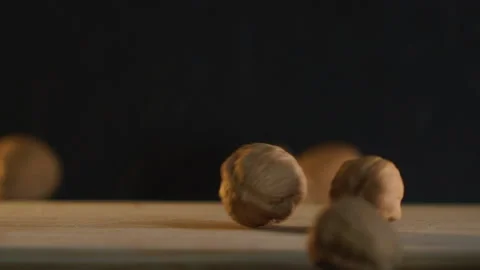 Drop Whole Walnuts one by one. Camera Isolated on Black Stock Footage 168155865