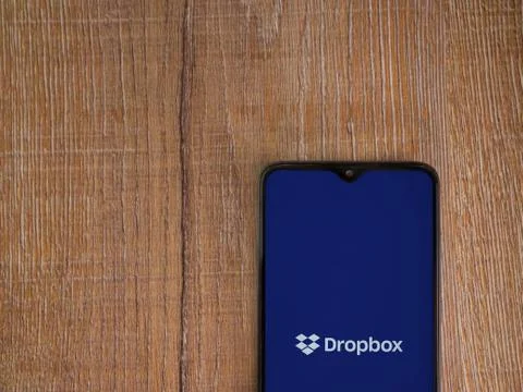 Dropbox app launch screen with logo on the display of a black mobile smartpho Stock Photos