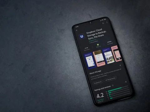 Dropbox app play store page on the display of a black mobile smartphone on da Stock Photos