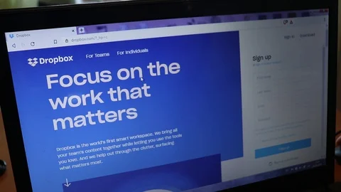 Dropbox website surfing scrolling in browser on laptop Stock Footage 128632448