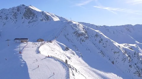 Dropdown over skiers on the ridge zoom out post process Stock Footage 128935086