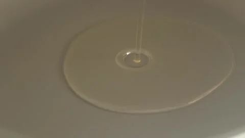 A Droplet of Clear Liquid on a Smooth Surface, Showcasing Abstract Aesthetics 動画素材 282992753