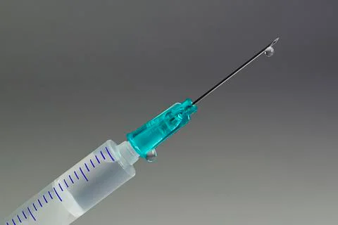 Droplet on the point of hypodermic needle 写真素材