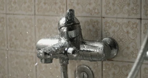 Droplets falling in super slow-motion into bathroom valve that regulates th.. Stock Footage 250235850