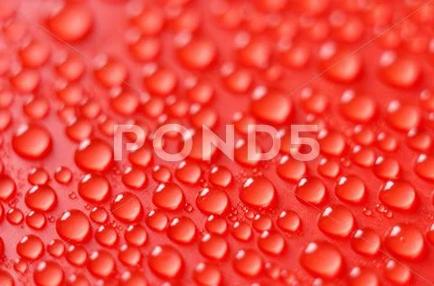 Droplets on red background Stock Photos