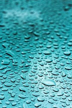 Droplets of water on a blue surface create an abstract pattern in a serene Stock Photos