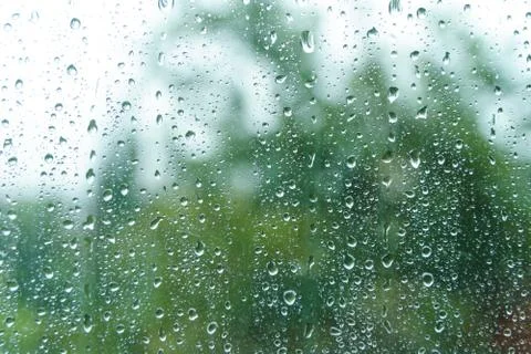 Droplets on window on rainy day. Stock Photos
