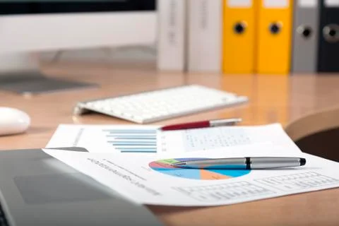 Dropped work Side view of working place with printed colored charts Stock Photos