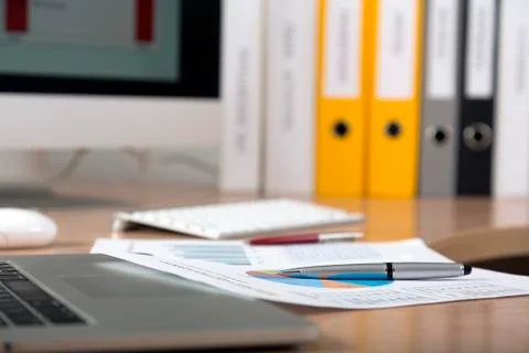 Dropped work Side view of working place with printed colored charts Stock Photos