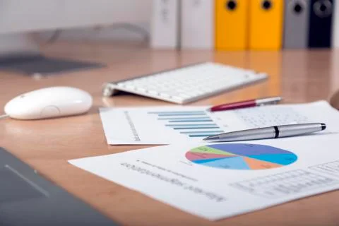 Dropped work Side view of working place with printed colored charts Stock Photos