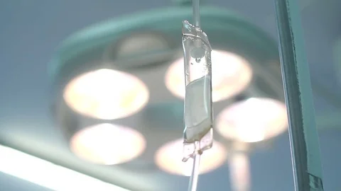 Dropper on the background of the included lamp in the operating room Stock Footage