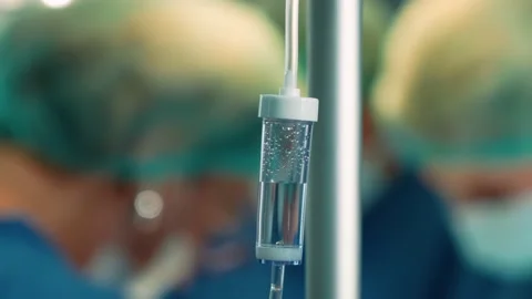 A dropper on the background of an operation in a hospital. Surgeons in the Stock Footage 219427131