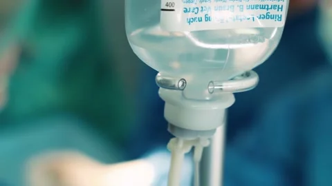 A dropper on the background of an operation in a hospital. Surgeons in the Stock Footage 219878222