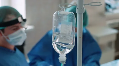 A dropper on the background of an operation in a hospital. Surgeons in the Stock Footage 228884010