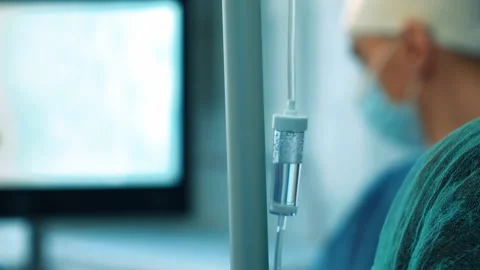A dropper on the background of an operation in a hospital. Surgeons in the Stock Footage 228884043