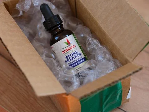 A dropper bottle of Amazon Stone Breaker liquid in a cardboard box Stock Photos