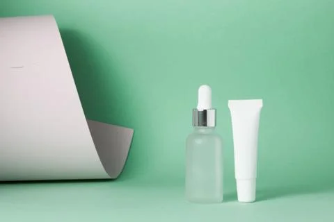 Dropper bottle and white plastic tube Stock Photos