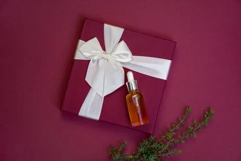 Dropper bottle on gift box Stock Photos